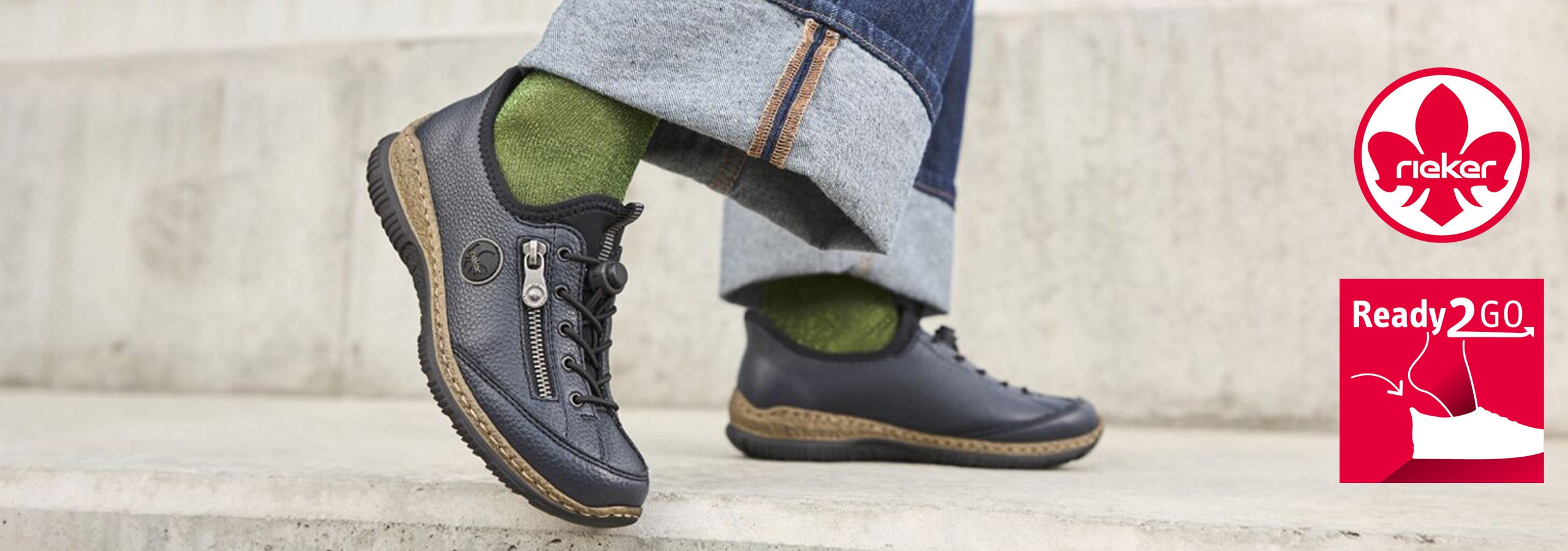 Person wearing gray shoes with green socks on a stone step, Rekare brand logo visible.