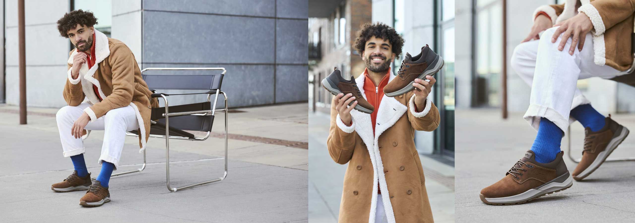 Man sitting on a chair wearing brown shoes, holding shoes, and sitting on a bench with blue socks.